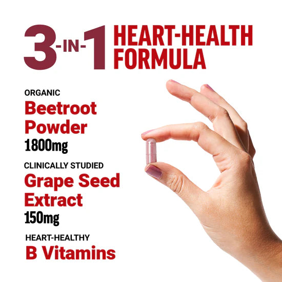 Hand holding a supplement capsule with heart-health formula details.
